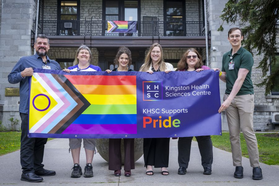 Pride staff community group with banner at KGH.