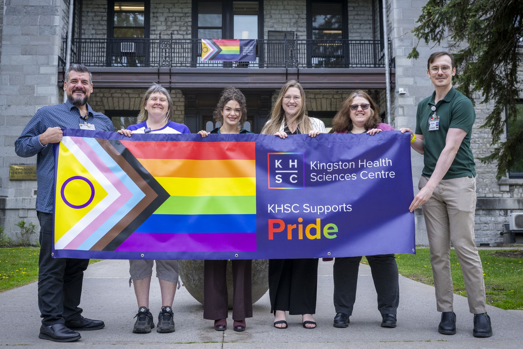 Pride staff community group with banner at KGH.
